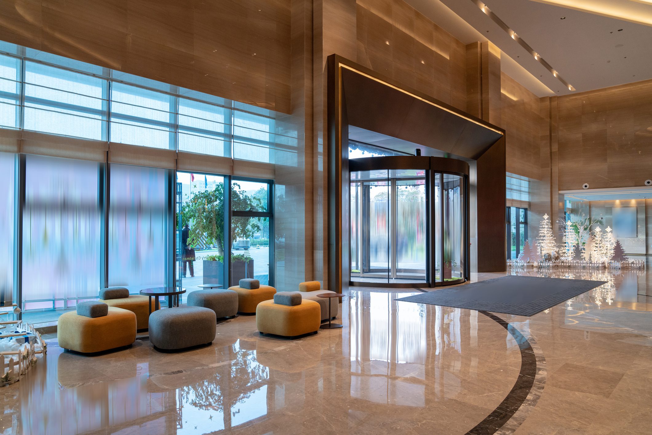 Modern hotel lobby with revolving door entrance.
