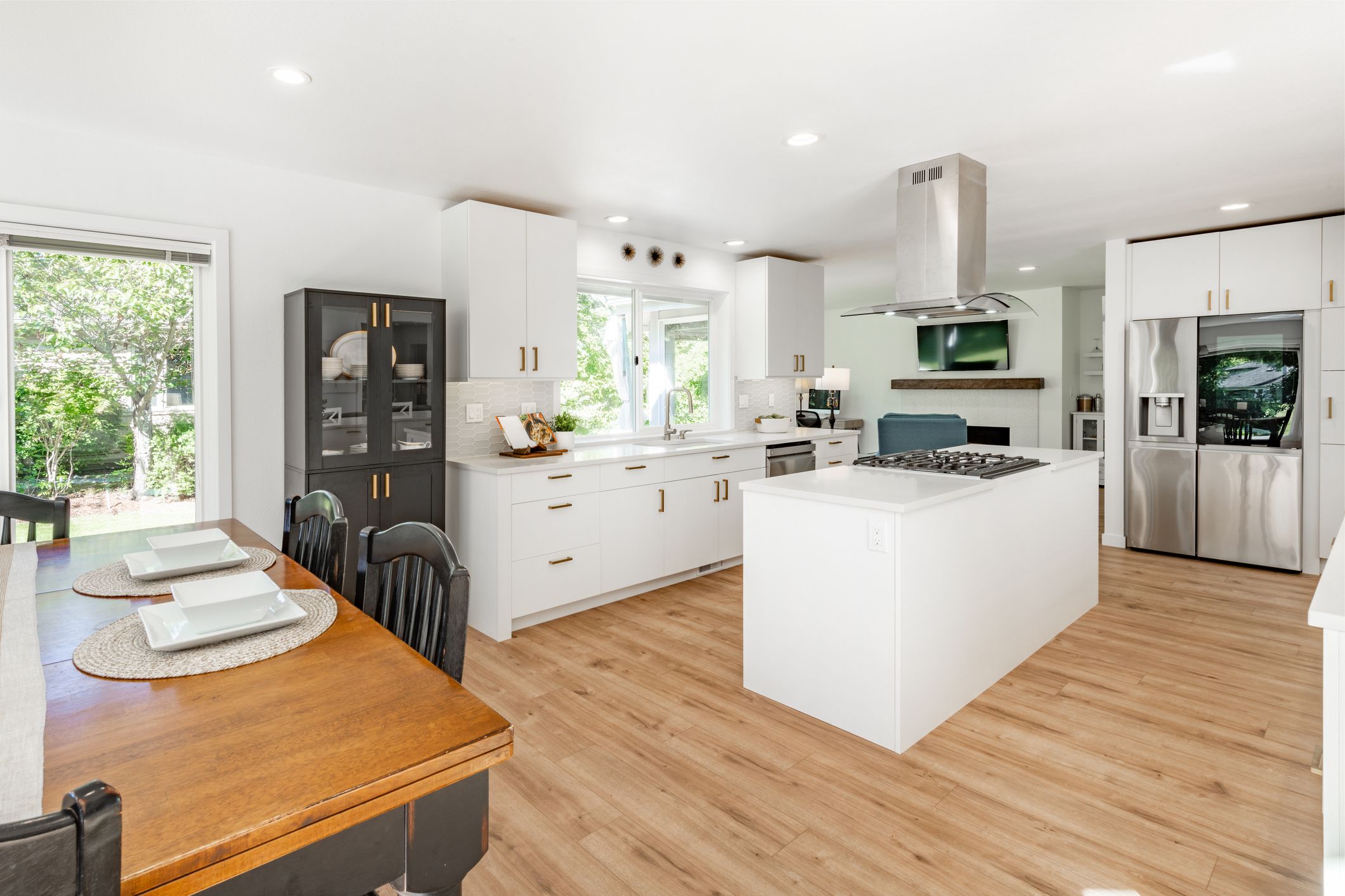 Modern kitchen with island and dining table.